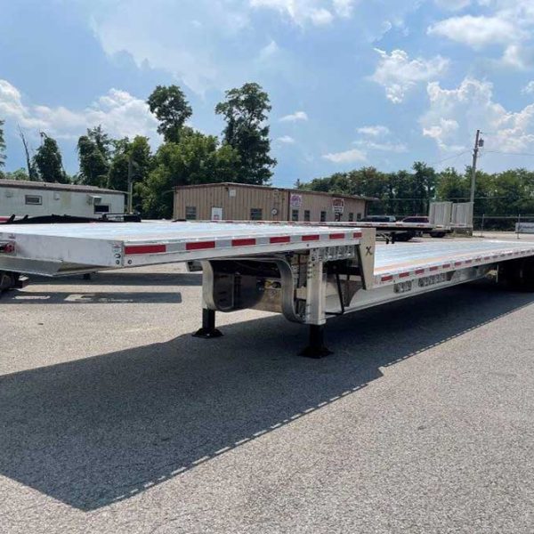 Empty drop-deck trailer with a lowered cargo deck