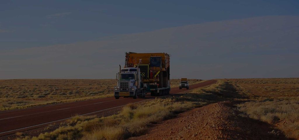 Heavy haul truck transporting oversized equipment on a specialized trailer