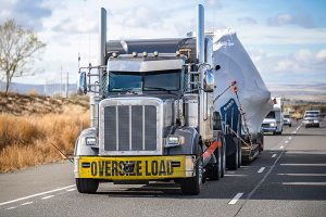 Heavy equipment secured on a specialized transport trailer