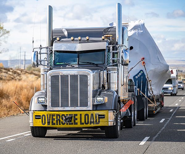 Heavy equipment secured on a specialized transport trailer