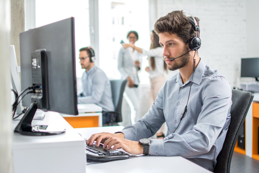 Customer service representative answering questions at a desk