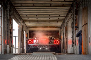 Sports car positioned inside an enclosed transport trailer