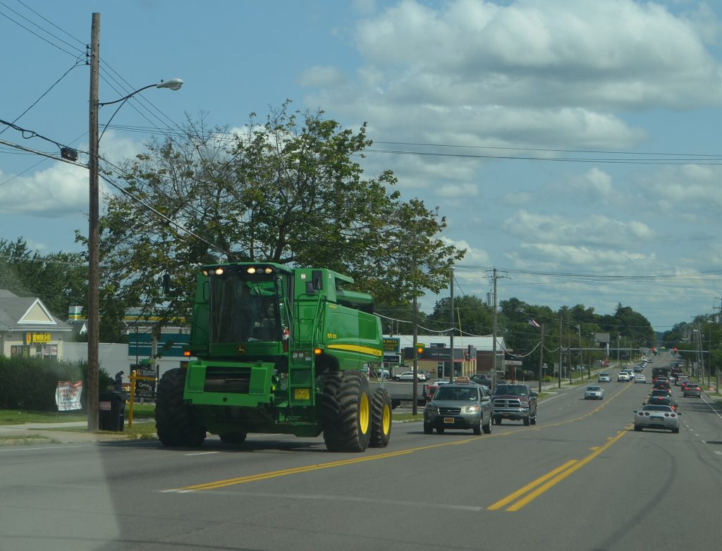 Large combine harvester traveling on a roadway