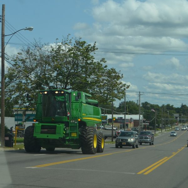 Large combine harvester traveling on a roadway