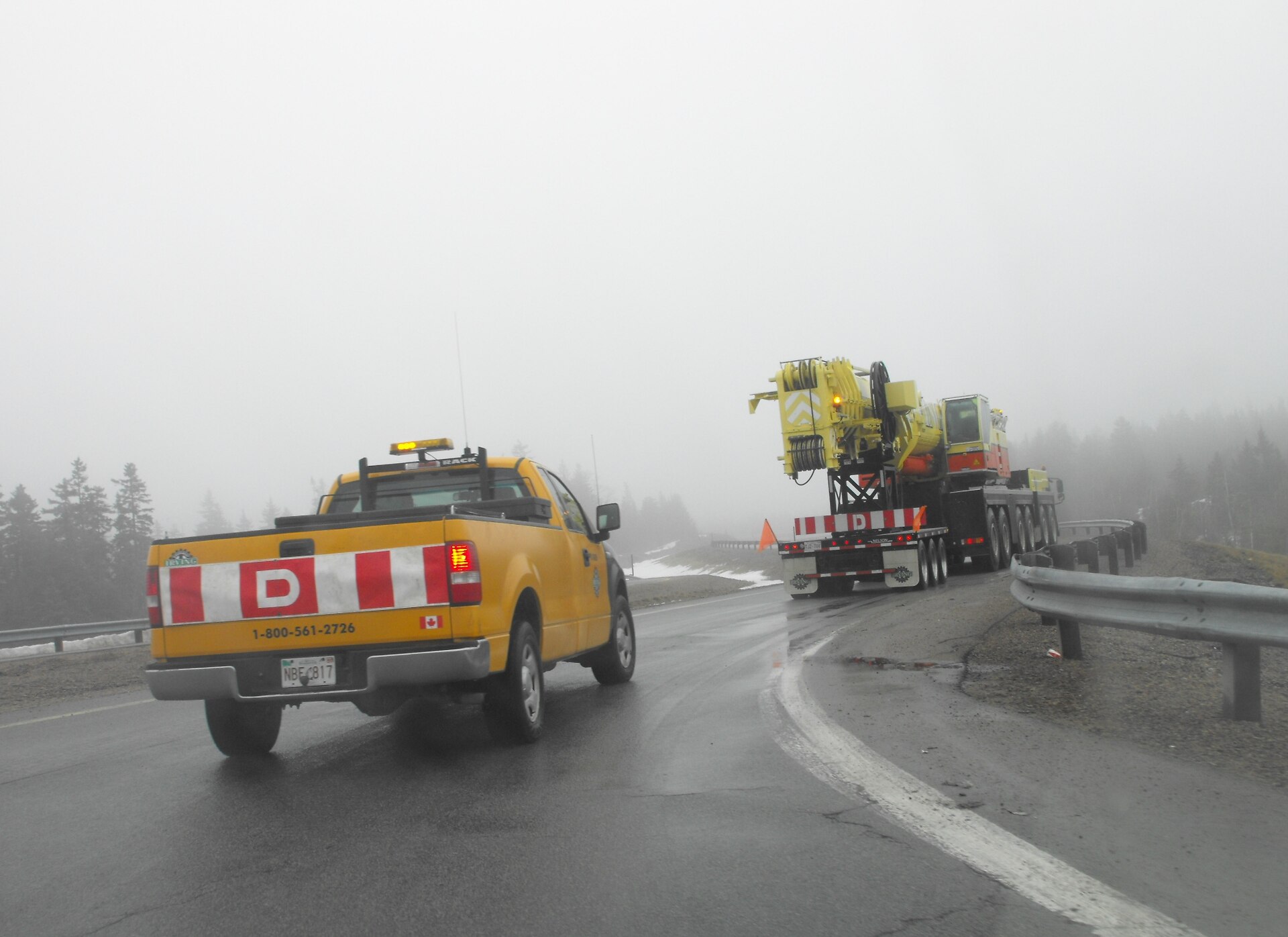 Wide-load truck traveling with an escort vehicle