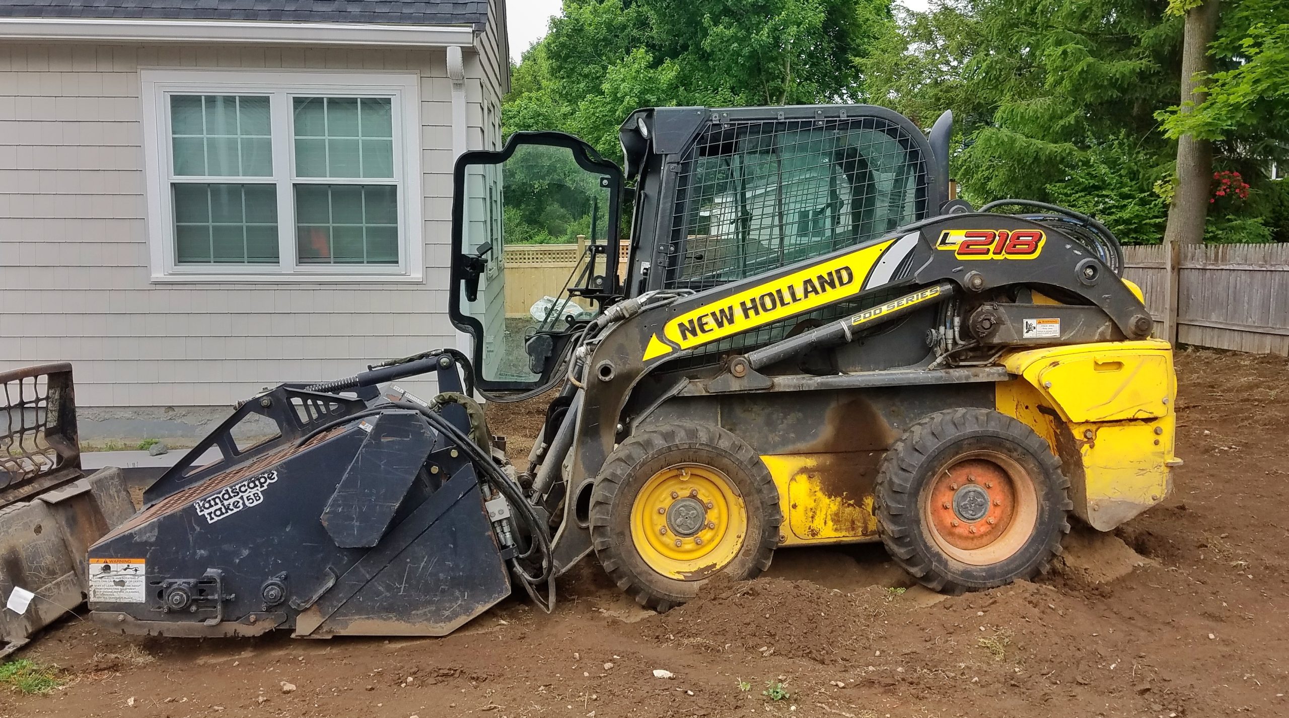 New Holland skid steer loader for construction equipment transport
