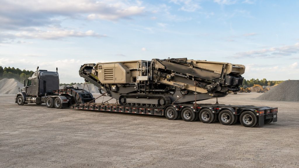 Mobile crusher secured on an RGN trailer for nationwide construction equipment transport