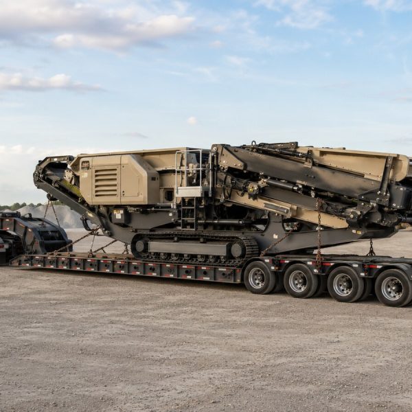 Mobile crusher secured on an RGN trailer for nationwide construction equipment transport