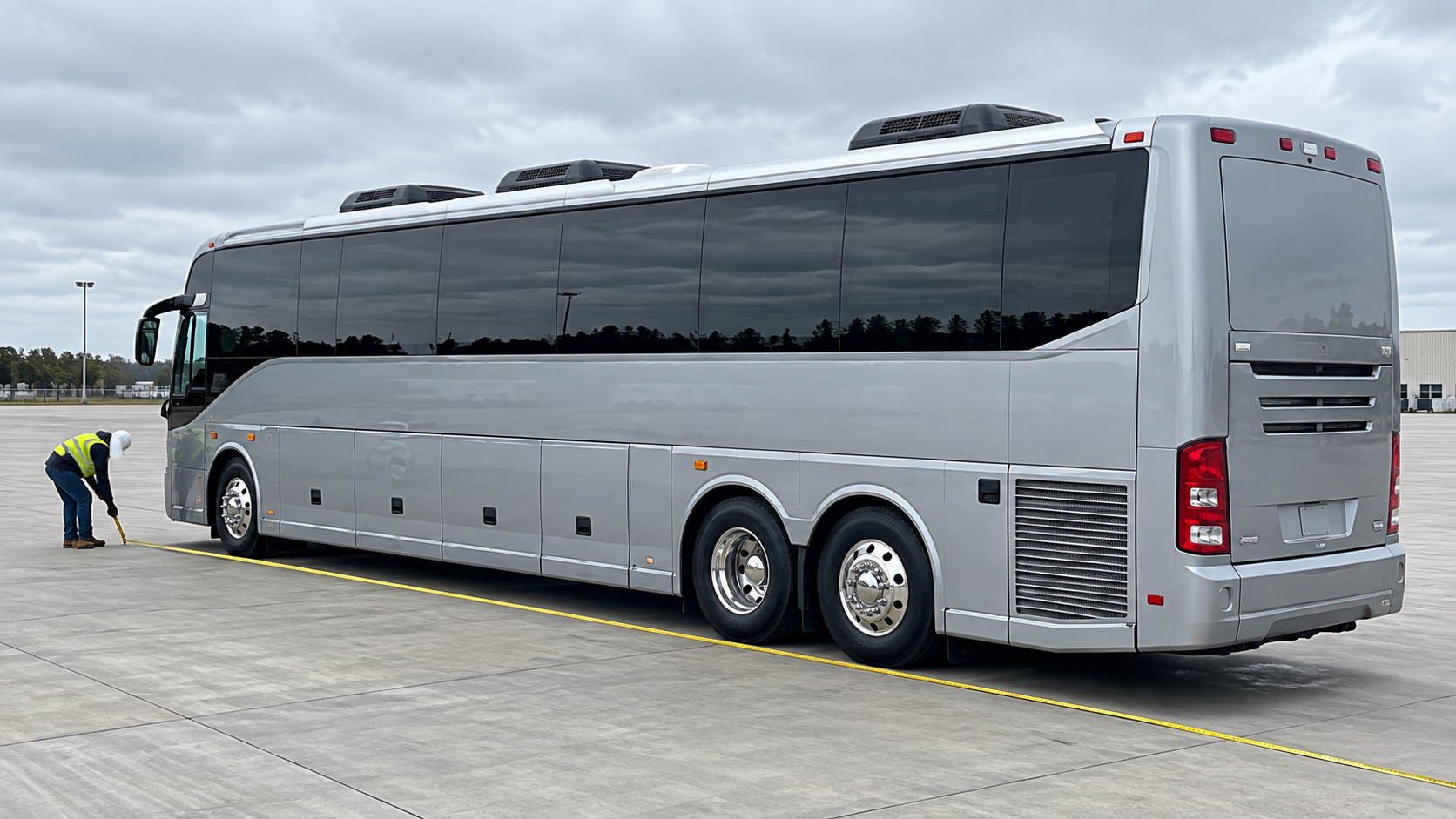 Illustration of a surveyor measuring a motorcoach on a level apron