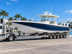 Large offshore fishing boat secured on a multi-axle marine transport trailer